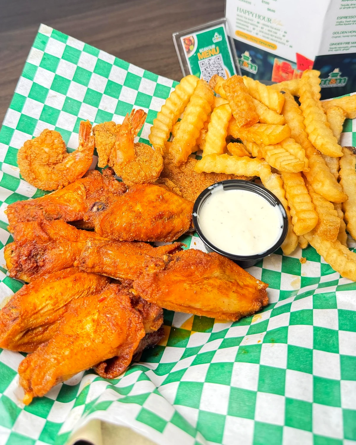 Wings, shrimp, fries, and dipping sauce at M&M African Kitchen & Bar